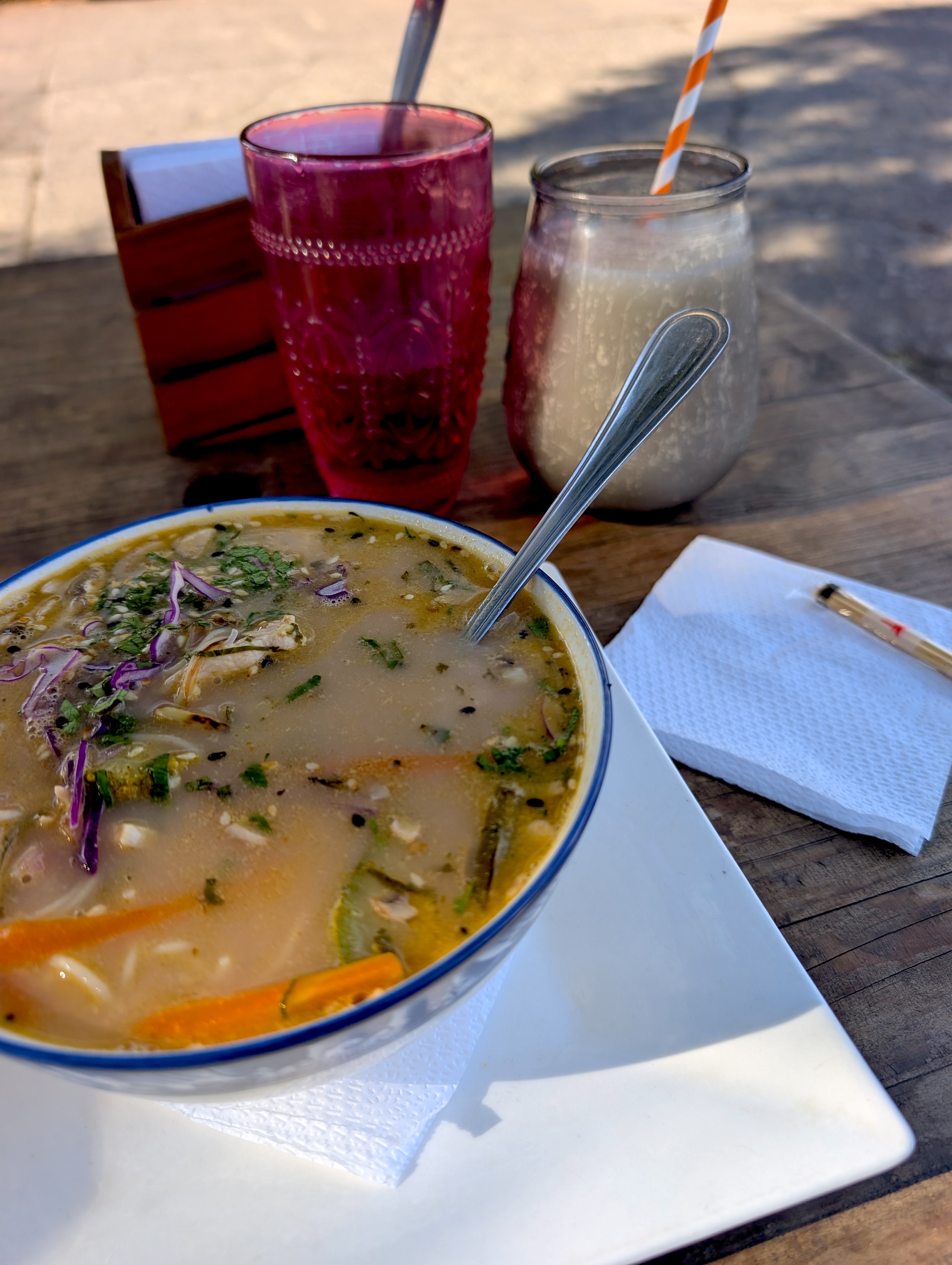 The soup Jose Manuel recommended, served with two fresh juices on a wooden table in Pucón