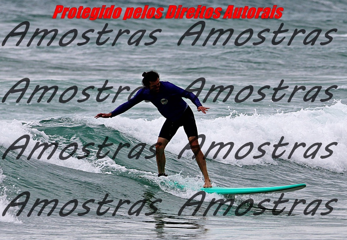 Jose Manuel surfing a wave with his arms outstretched