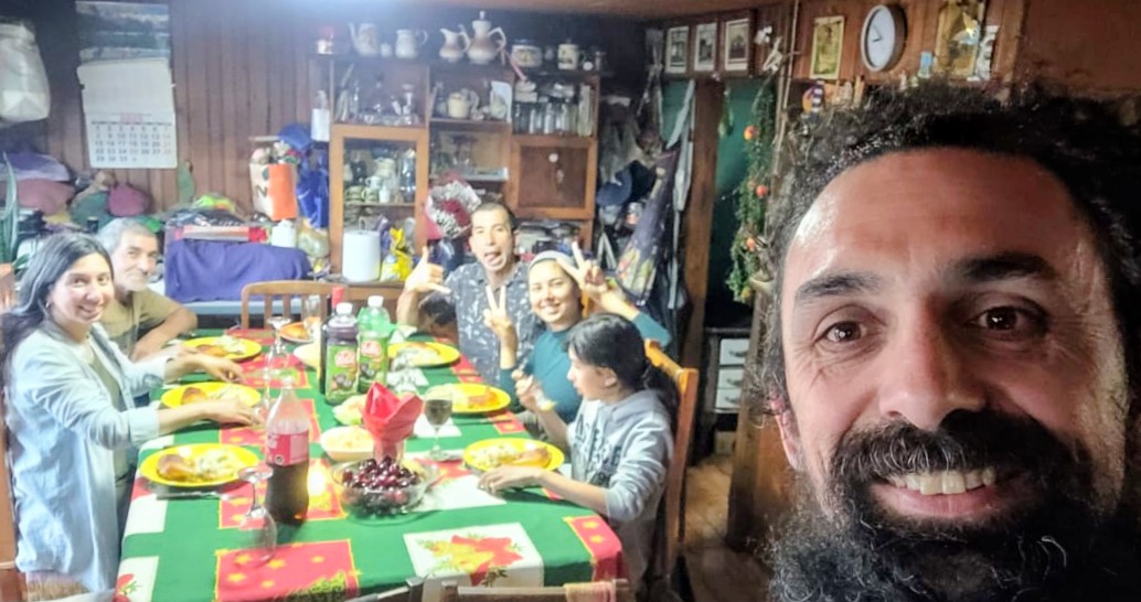 A selfie of Jose Manuel with family gathered around a festive dinner table